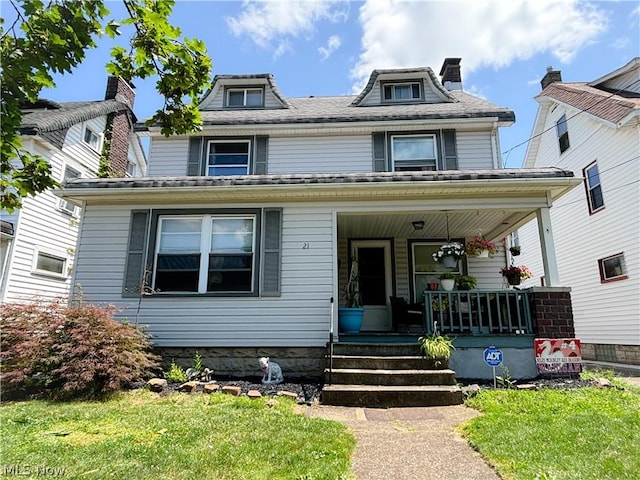 view of front of house with a porch and a front lawn