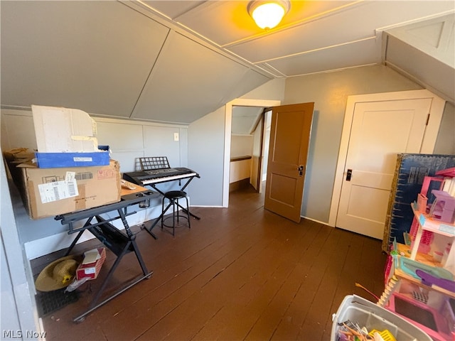 interior space featuring dark hardwood / wood-style flooring and lofted ceiling