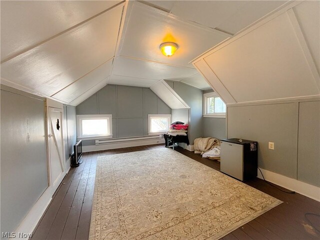 bonus room with lofted ceiling, dark hardwood / wood-style flooring, and baseboard heating