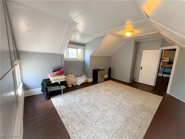 additional living space with lofted ceiling and dark wood-type flooring