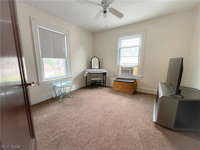 interior space featuring carpet flooring, cooling unit, and ceiling fan