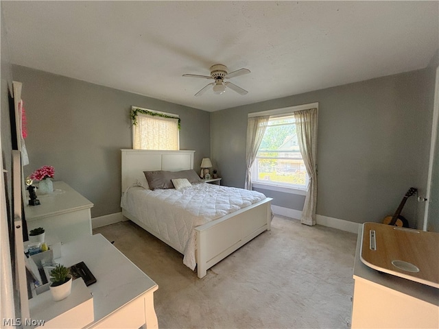 bedroom featuring ceiling fan and light colored carpet