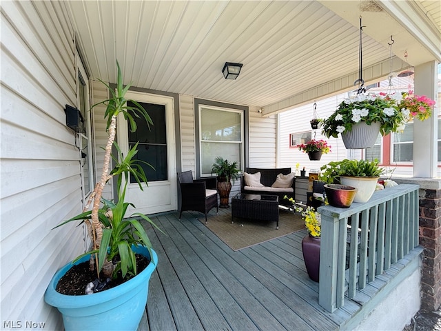 deck with a porch and an outdoor hangout area