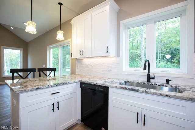 kitchen with pendant lighting, sink, white cabinetry, black dishwasher, and vaulted ceiling