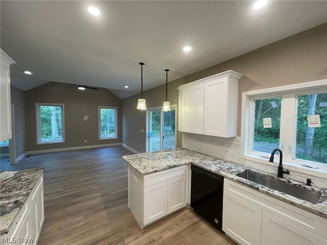 kitchen featuring sink, white cabinetry, decorative light fixtures, black dishwasher, and kitchen peninsula