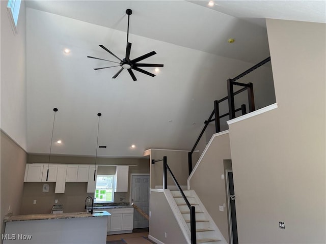 14992 Carol Dr, Maple Heights, OH 44137 - kitchen featuring white cabinets, ceiling fan, recessed lighting, stone counters, and a sink
