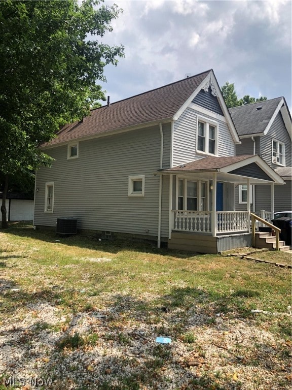 exterior space featuring a lawn, central AC, and covered porch