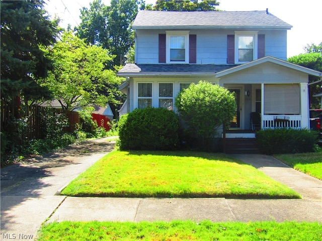 view of front of home with covered porch and a front yard