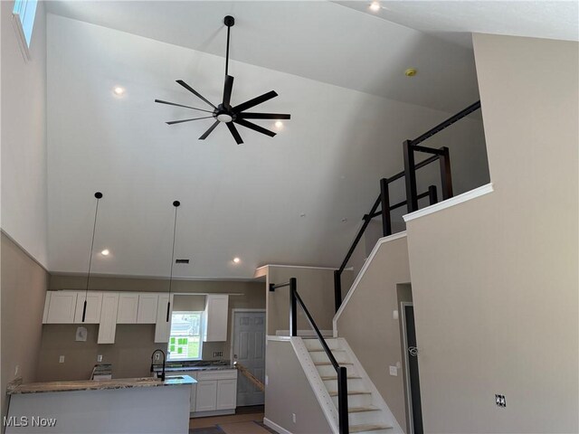 14501 Kennerdown Ave, Maple Heights, OH 44137 - kitchen featuring white cabinets, ceiling fan, recessed lighting, stone counters, and a sink