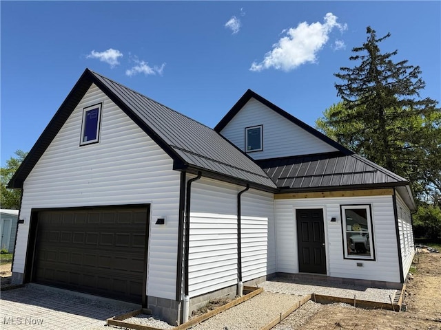 14501 Kennerdown Ave, Maple Heights, OH 44137 - view of front of home featuring a standing seam roof, a garage, and metal roof