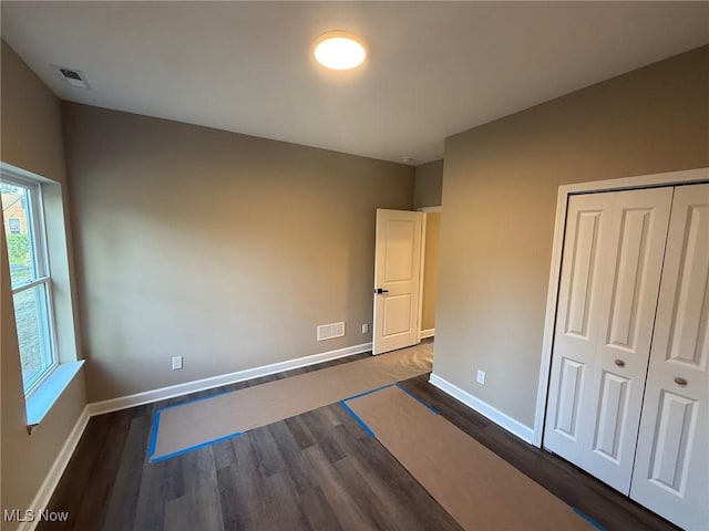 14501 Kennerdown Ave, Maple Heights, OH 44137 - unfurnished bedroom featuring dark wood-style flooring and a closet