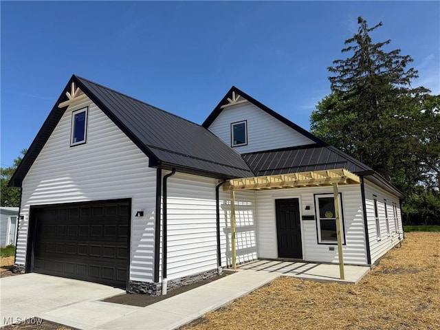 14501 Kennerdown Ave, Maple Heights, OH 44137 - modern farmhouse style home featuring a garage, a metal roof, and driveway
