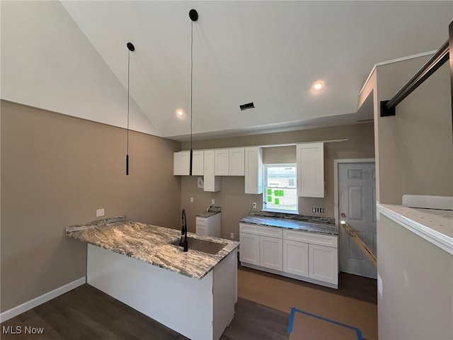 17204 Maple Heights Blvd, Maple Heights, OH 44137 - kitchen with washer and clothes dryer, a sink, dark wood-style flooring, a peninsula, and white cabinets