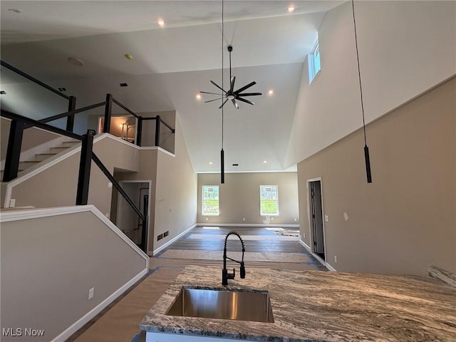 17204 Maple Heights Blvd, Maple Heights, OH 44137 - kitchen with a sink, open floor plan, high vaulted ceiling, wood finished floors, and baseboards