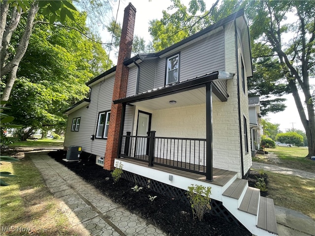 exterior space with central air condition unit and covered porch