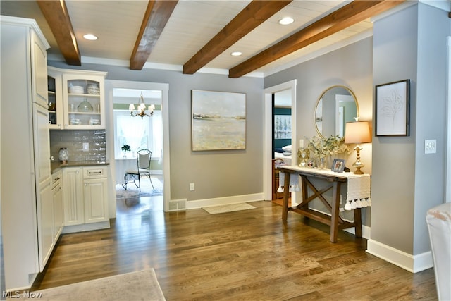 interior space with white cabinetry, dark hardwood / wood-style flooring, and beam ceiling