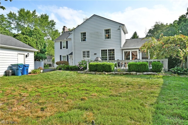 back of property featuring a lawn