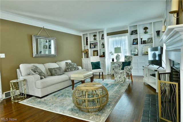 living room featuring crown molding, dark wood-type flooring, and a brick fireplace