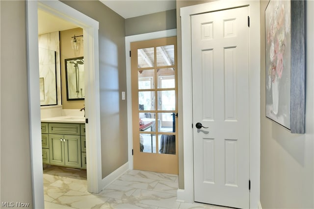 entryway featuring sink and light tile patterned flooring