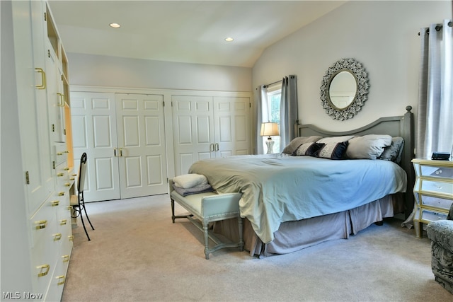 carpeted bedroom with lofted ceiling