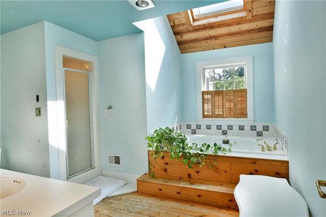 bathroom featuring independent shower and bath, sink, wooden ceiling, and vaulted ceiling with skylight