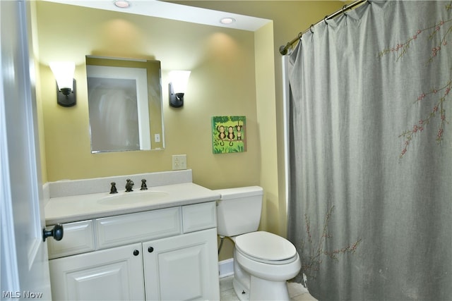 bathroom with tile patterned floors, vanity, and toilet