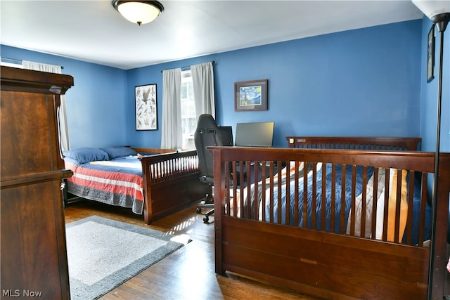 bedroom with wood-type flooring