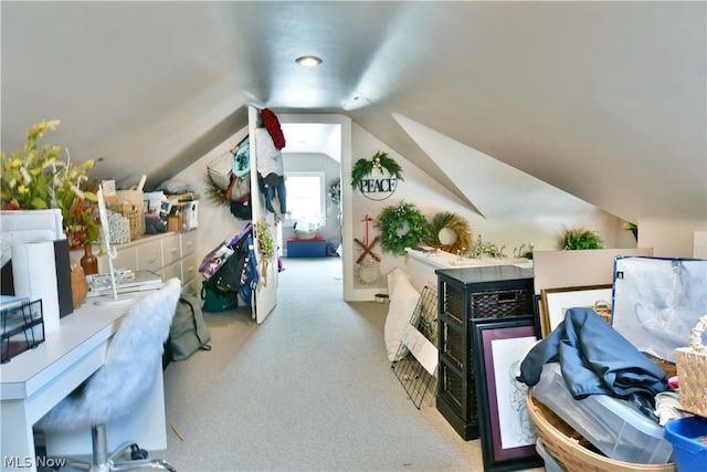 carpeted office featuring lofted ceiling