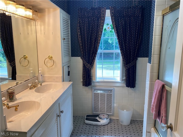 bathroom featuring vanity, tile walls, tile patterned floors, and plenty of natural light