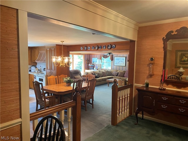 dining room with ornamental molding, dark colored carpet, and an inviting chandelier