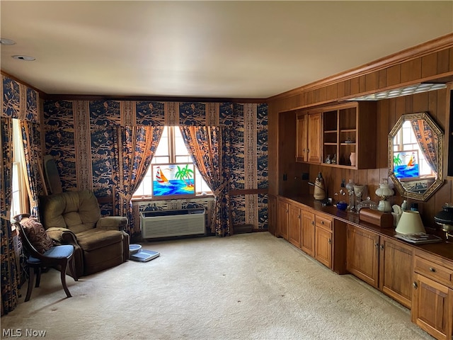 interior space with a wall mounted air conditioner, crown molding, wood walls, and plenty of natural light