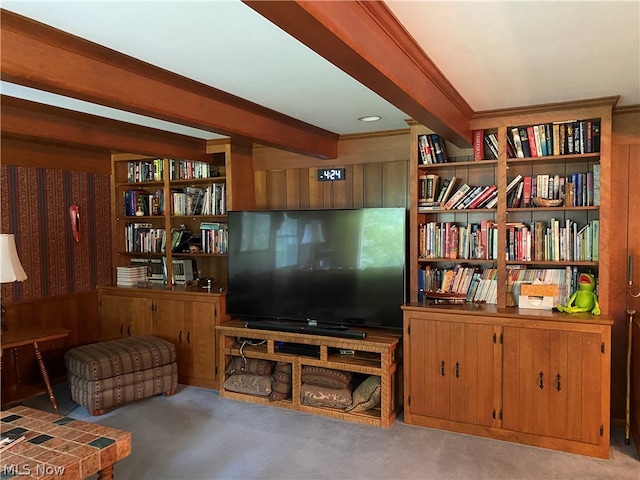 carpeted living room with beam ceiling