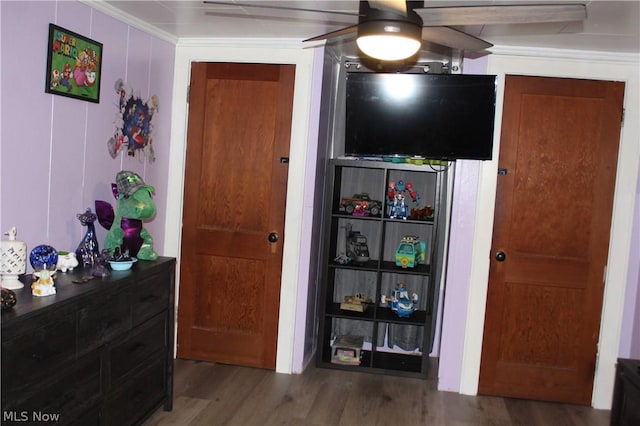 bedroom featuring ceiling fan, ornamental molding, and hardwood / wood-style floors