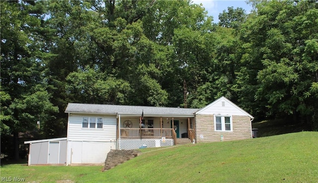 view of front of house with covered porch and a front yard