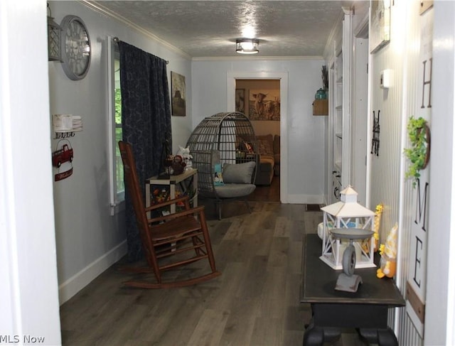 corridor with crown molding, dark hardwood / wood-style floors, and a textured ceiling