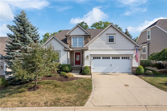 craftsman house with a garage and a front lawn