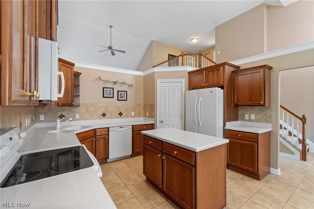 kitchen featuring light tile patterned flooring, ceiling fan, high vaulted ceiling, white appliances, and sink