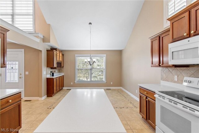 kitchen with light tile patterned flooring, backsplash, and white appliances