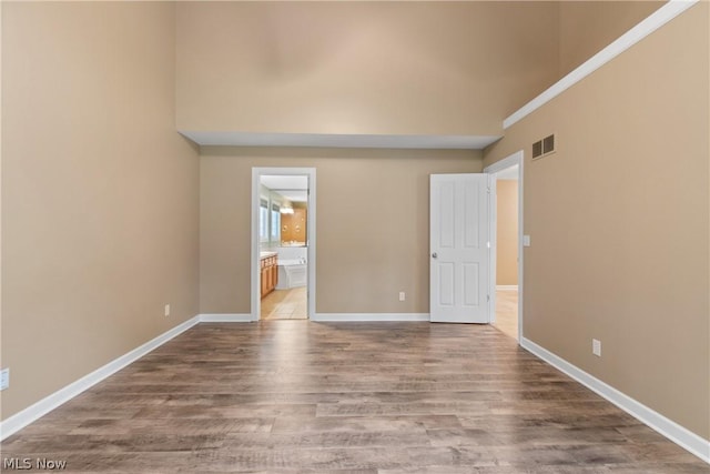 unfurnished room with hardwood / wood-style flooring