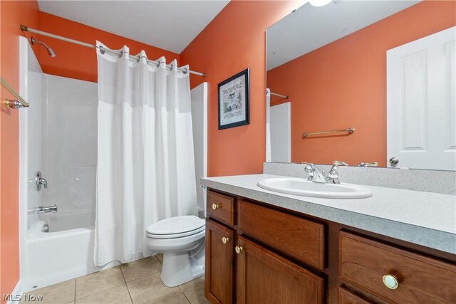 full bathroom with tile patterned floors, vanity, toilet, and shower / bath combination with curtain