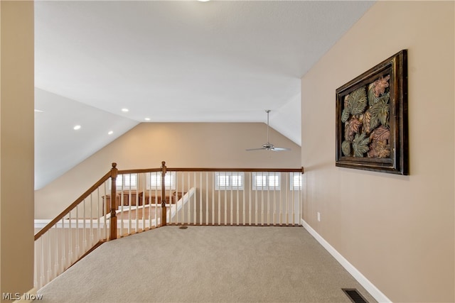 hall featuring lofted ceiling and carpet floors