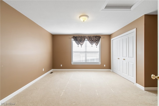 unfurnished bedroom featuring carpet and a closet