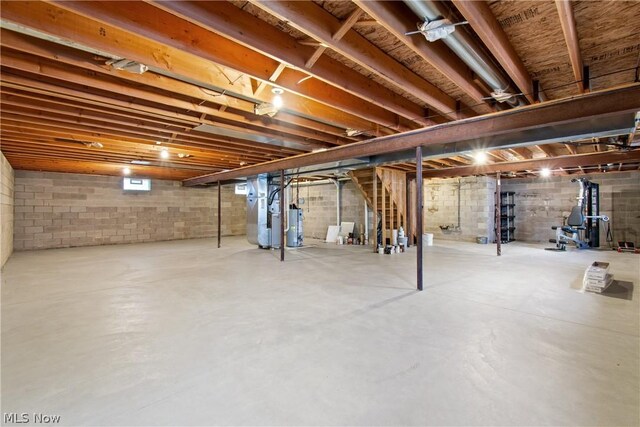 basement with water heater and heating unit