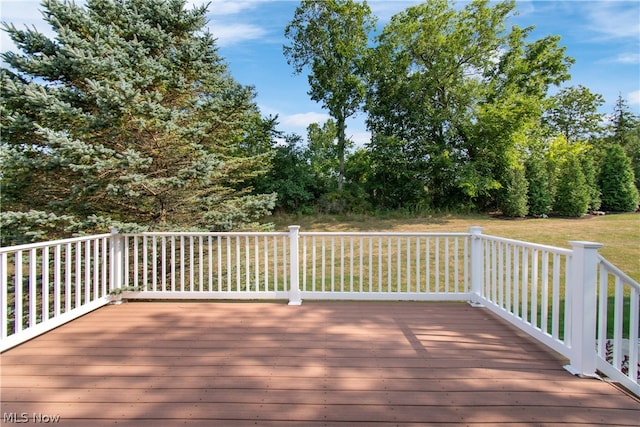 wooden terrace featuring a lawn