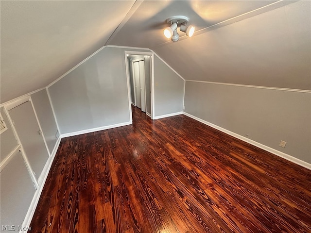 bonus room with lofted ceiling and dark wood-type flooring