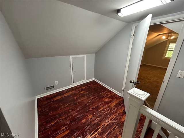 additional living space featuring hardwood / wood-style flooring and lofted ceiling