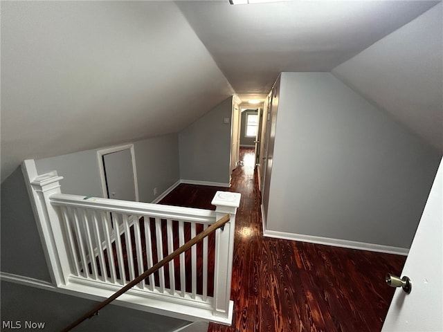 stairway with lofted ceiling and wood-type flooring