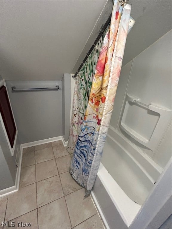 bathroom with tile patterned flooring and shower / tub combo