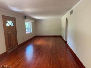 entryway with crown molding and dark wood-type flooring