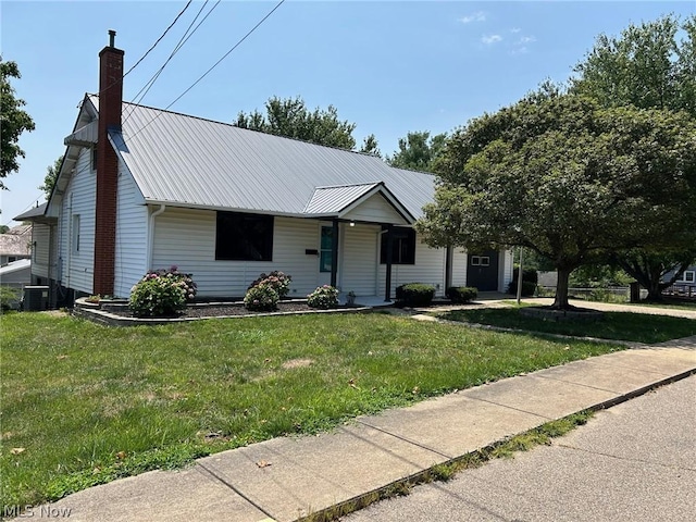 view of front of property featuring a front lawn and central air condition unit